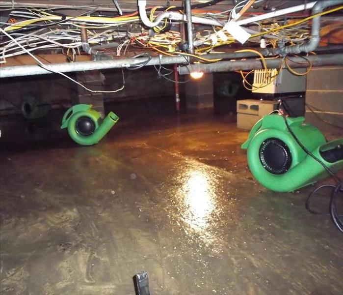 Crawl space with water damage and air movers 