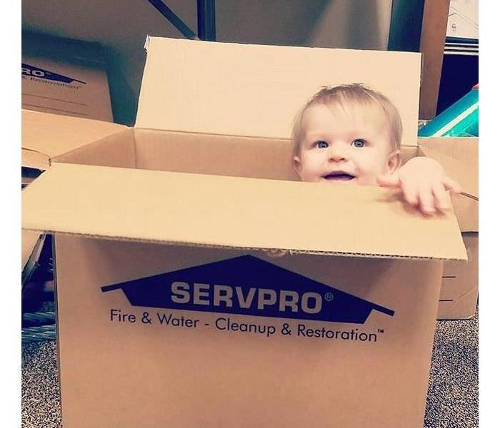 baby in a SERVPRO moving box