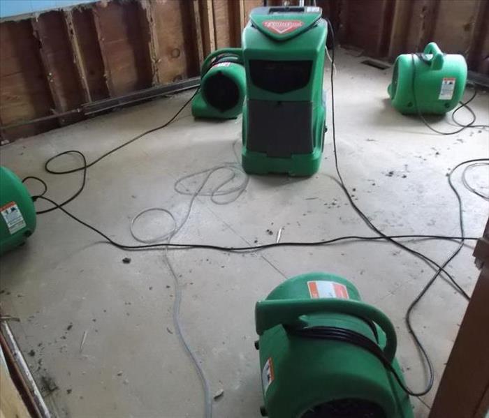 air movers and equipment being used to dry water damage